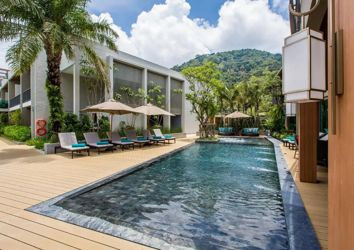 AtEase Phuket Patong Outdoor Rectangular Swimming Pool with Lounge Chairs and Tropical Surroundings at Patong Beach