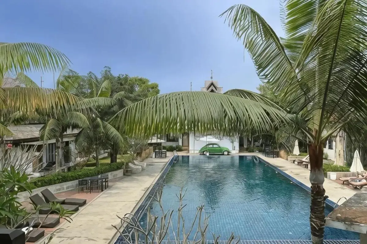Outdoor Rectangular Swimming Pool with Lounge Chairs and Tropical Vegetation in Chiang Mai