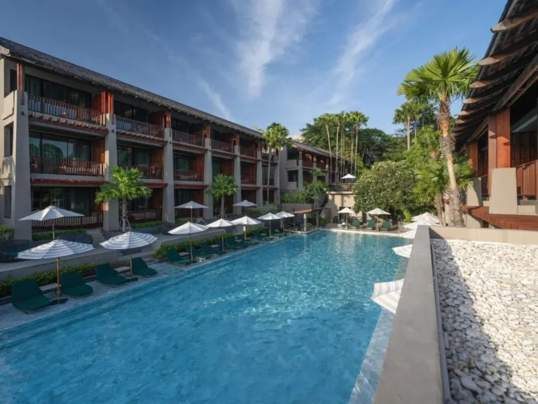 Outdoor Rectangular Swimming Pool with Lounge Chairs and Umbrellas at Patong Beach Resort