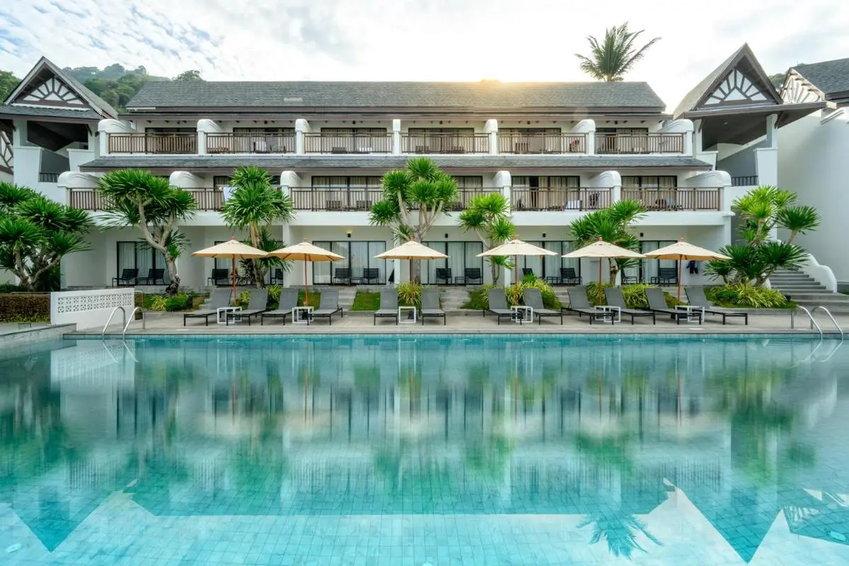 Andamantra Resort and Villa Phuket Outdoor Rectangular Swimming Pool with Lounge Chairs and Umbrellas at Patong Beach