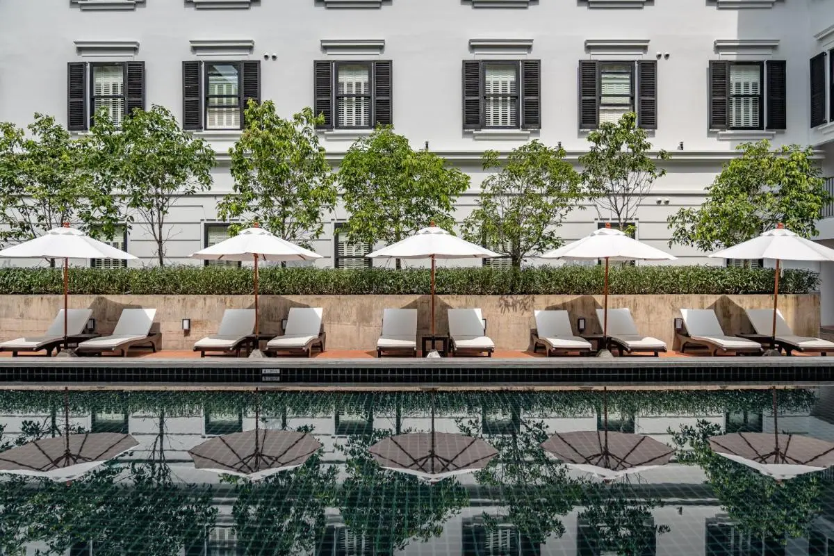 Outdoor Rectangular Swimming Pool with Lounge Chairs and Umbrellas in Chang Phueak Chiang Mai