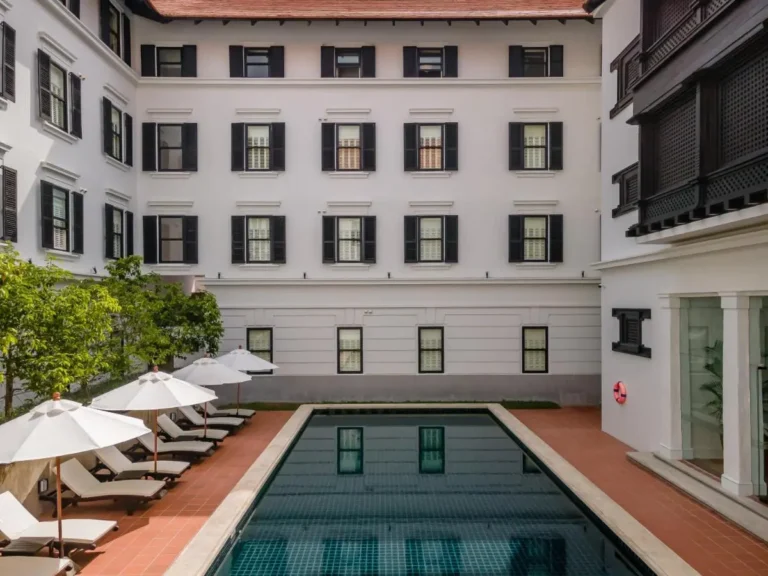 Outdoor Rectangular Swimming Pool with Lounge Chairs and Umbrellas in Chang Phueak Chiang Mai