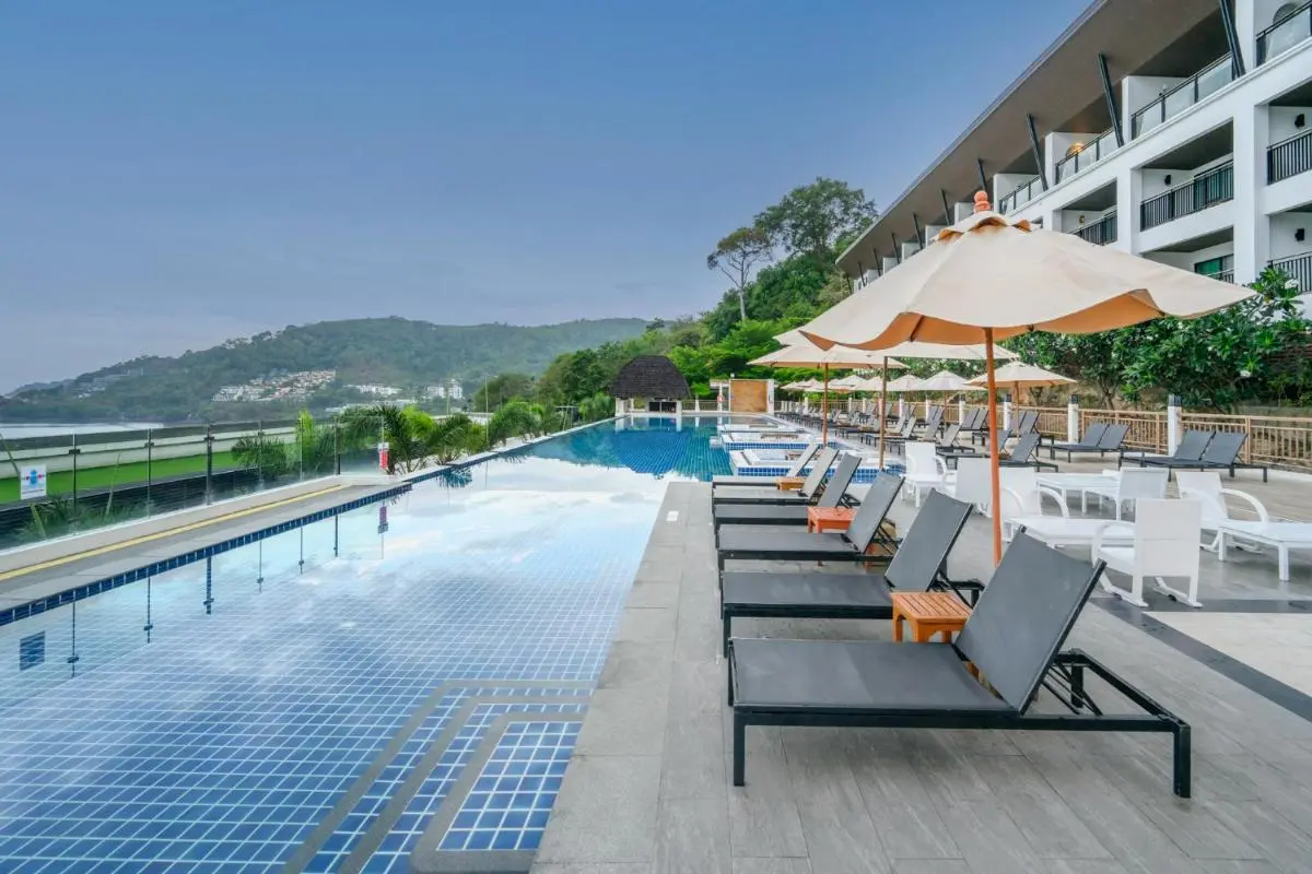 Andamantra Resort and Villa Phuket Outdoor Rectangular Swimming Pool with Lounge Chairs and Umbrellas Near Patong Beach Phuket Province