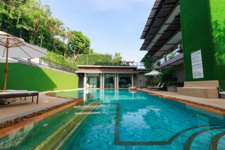 Outdoor Rectangular Swimming Pool with Lounge Chairs and Wellness Facility in Ban Bo Rae
