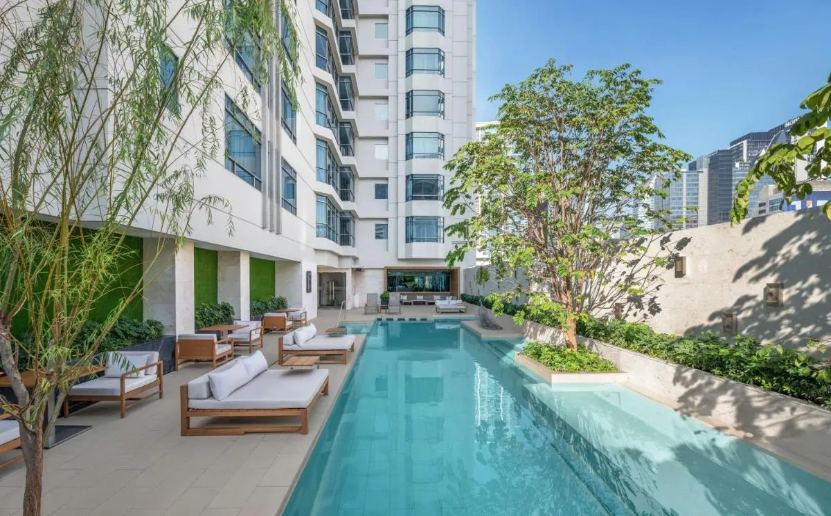 DoubleTree by Hilton Bangkok Ploenchit Outdoor Rectangular Swimming Pool with Lounge Seating and Urban Views in Khlong Toei Bangkok
