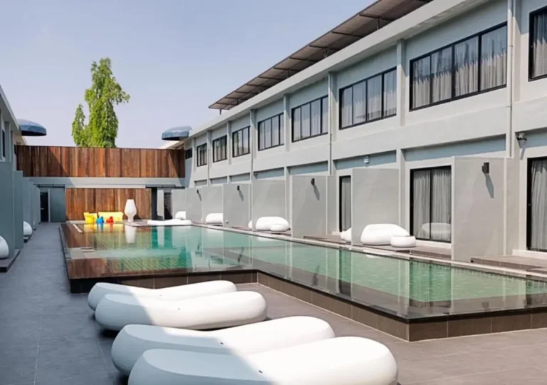 Outdoor Rectangular Swimming Pool with Modern Lounge Chairs in Huai Khwang Courtyard