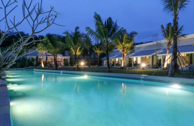 Outdoor Rectangular Swimming Pool with Underwater Lighting and Palm Trees in Phuket Town
