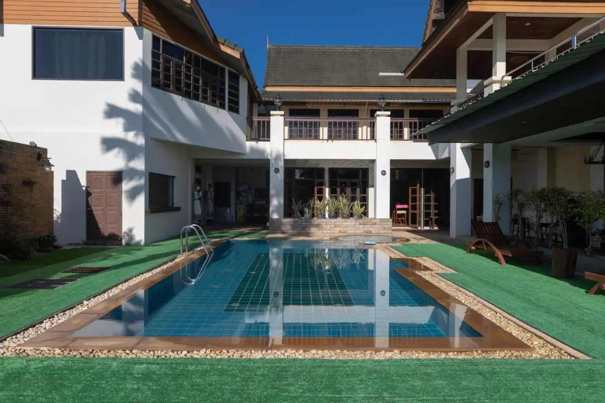 Blue Beach Grand Resort And Spa Outdoor Rectangular Swimming Pool with Wooden Balcony and Lounge Chairs at Rawai Beach