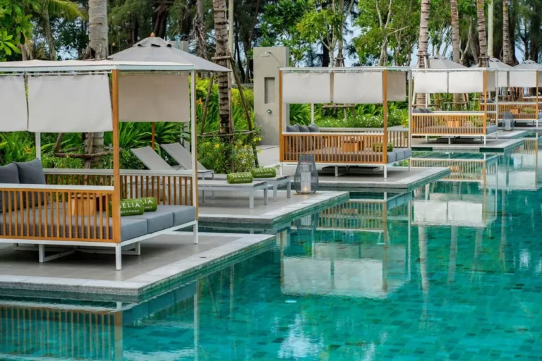 Outdoor Rectangular Swimming Pool with Wooden Cabanas and Tropical Surroundings at Mai Khao Beach Outdoor Rectangular Swimming Pool with Wooden Cabanas and Tropical Surroundings at Mai Khao Beach