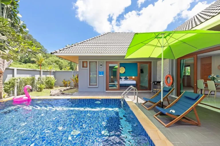 Outdoor Residential Pool Area with Lounge Chairs and Flamingo Float at Rawai Beach