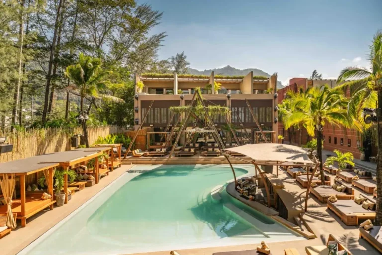 Outdoor Resort Pool Area with Swim-Up Bar and Wooden Lounge Beds at Kamala Beach