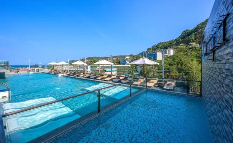 Outdoor Rooftop Pool Area with Loungers and Scenic Views at Patong Beach
