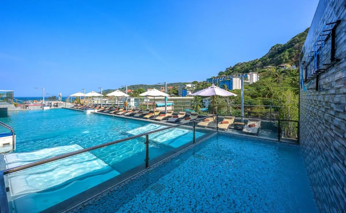 Outdoor Rooftop Pool Area with Loungers and Scenic Views at Patong Beach