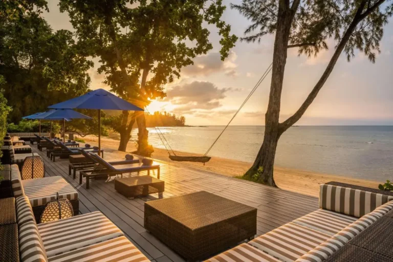 Outdoor Seating Area with Lounge Chairs and Wooden Swing at Kamala Beach Sunset