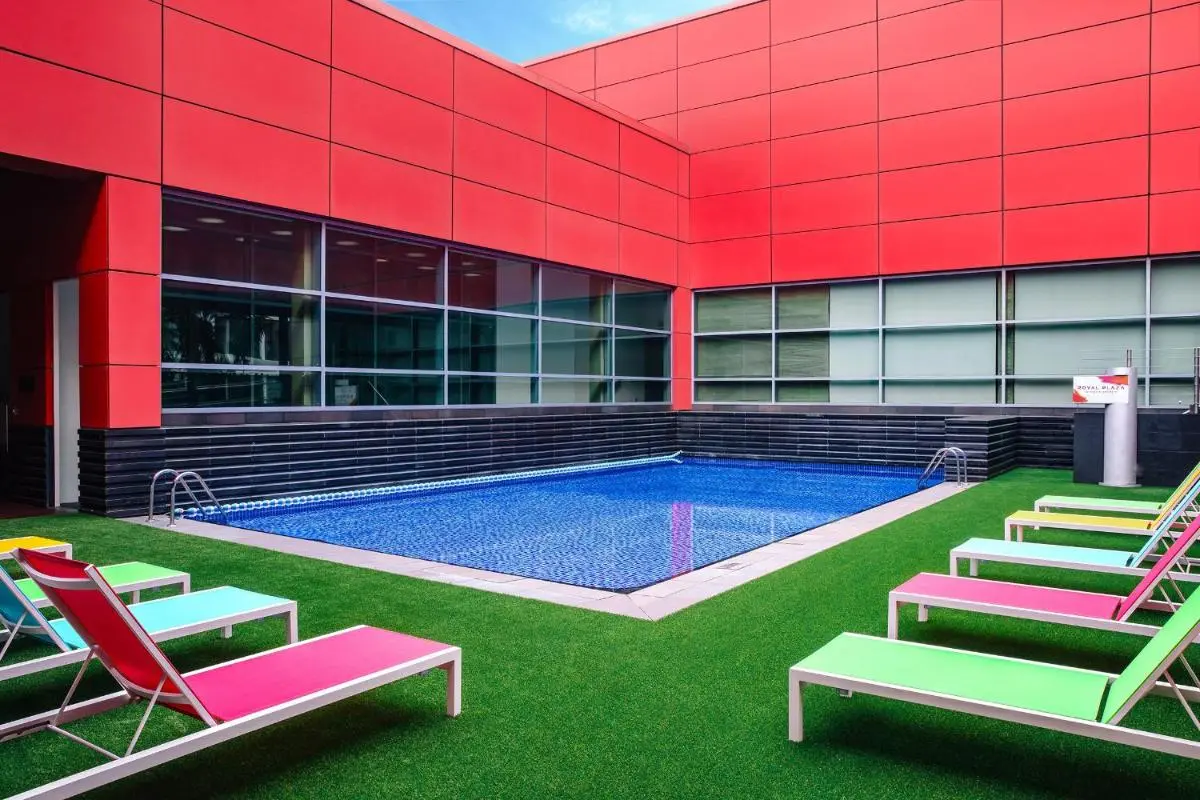Outdoor Swimming Pool and Lounge Area with Artificial Grass in Orchard