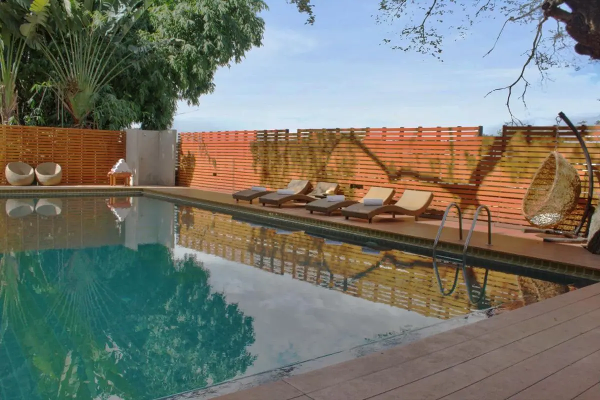 Outdoor Swimming Pool and Relaxation Area with Lounge Chairs in Chiang Mai