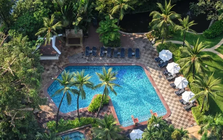 Outdoor Swimming Pool and Spa Area with Lounge Chairs and Tropical Landscaping in Chatuchak