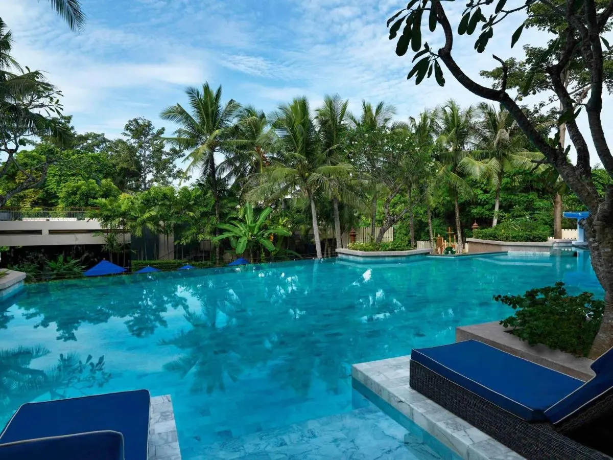 Outdoor Swimming Pool Area Surrounded by Lush Tropical Vegetation at Kata Beach