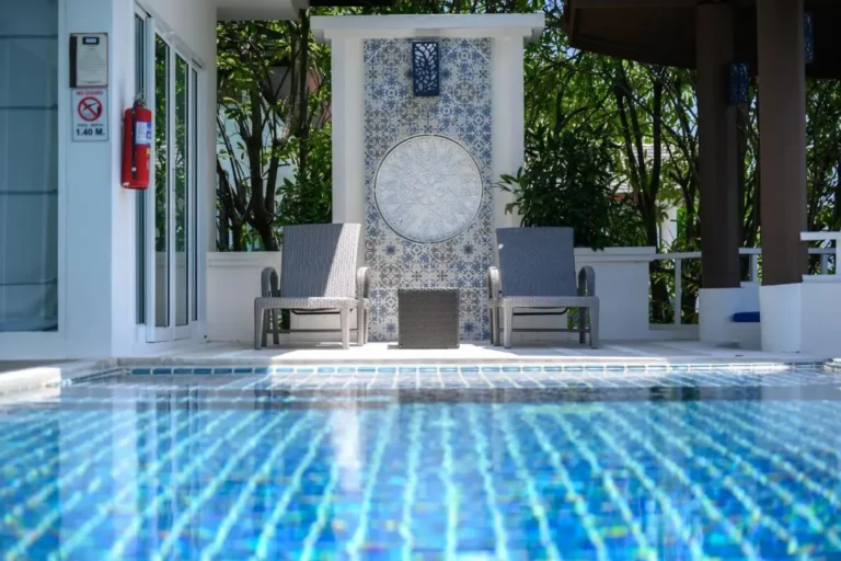 Outdoor Swimming Pool Area with Blue Mosaic Tiles and Relaxing Seating at Patong Beach