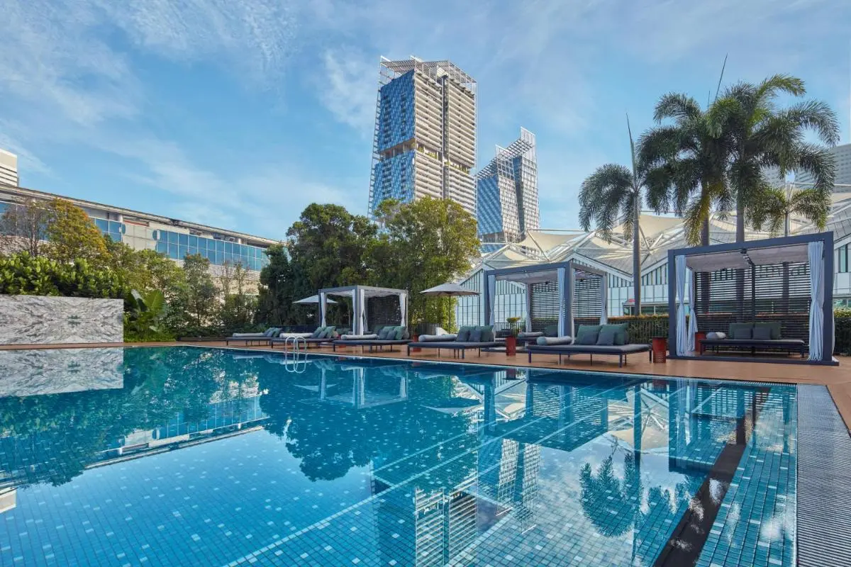 Outdoor Swimming Pool Area with Cabanas and Lounge Chairs in Marina Bay