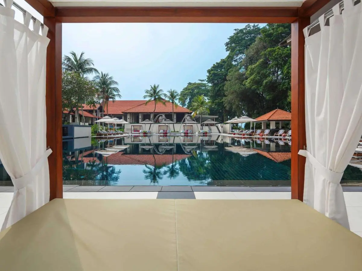Outdoor Swimming Pool Area with Cabanas and Lounge Seating in Singapore