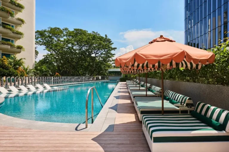 Outdoor Swimming Pool Area with Lounge Beds and Umbrellas in Orchard Singapore