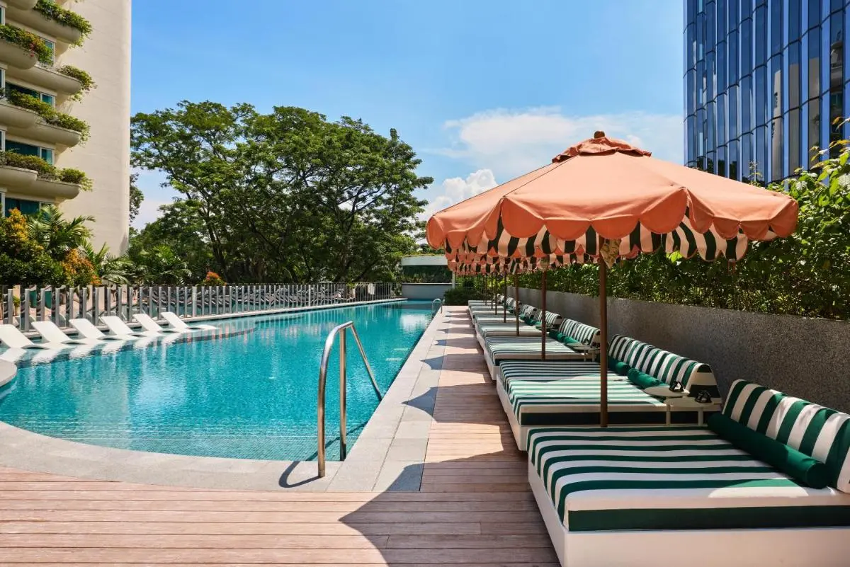 The Standard Singapore Outdoor Swimming Pool Area with Lounge Beds and Umbrellas in Orchard Singapore