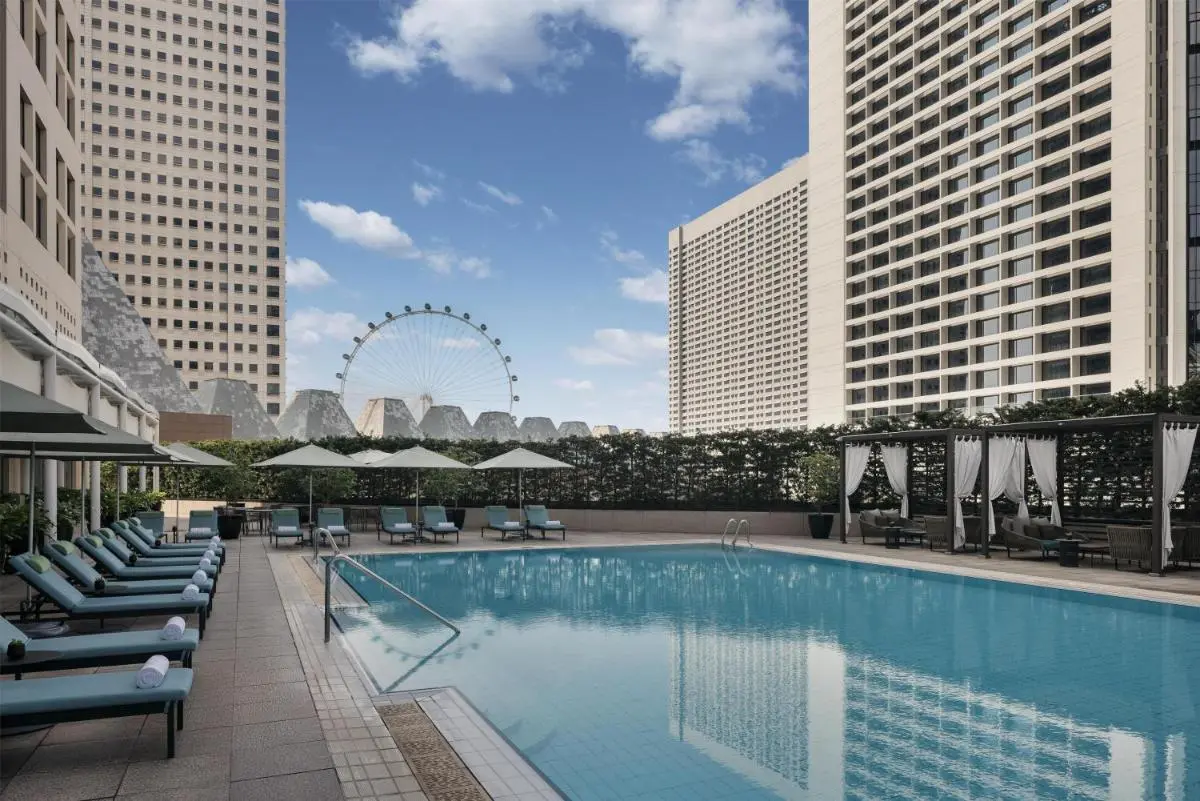 Outdoor Swimming Pool Area with Lounge Chairs and Cabanas in Marina Bay Singapore