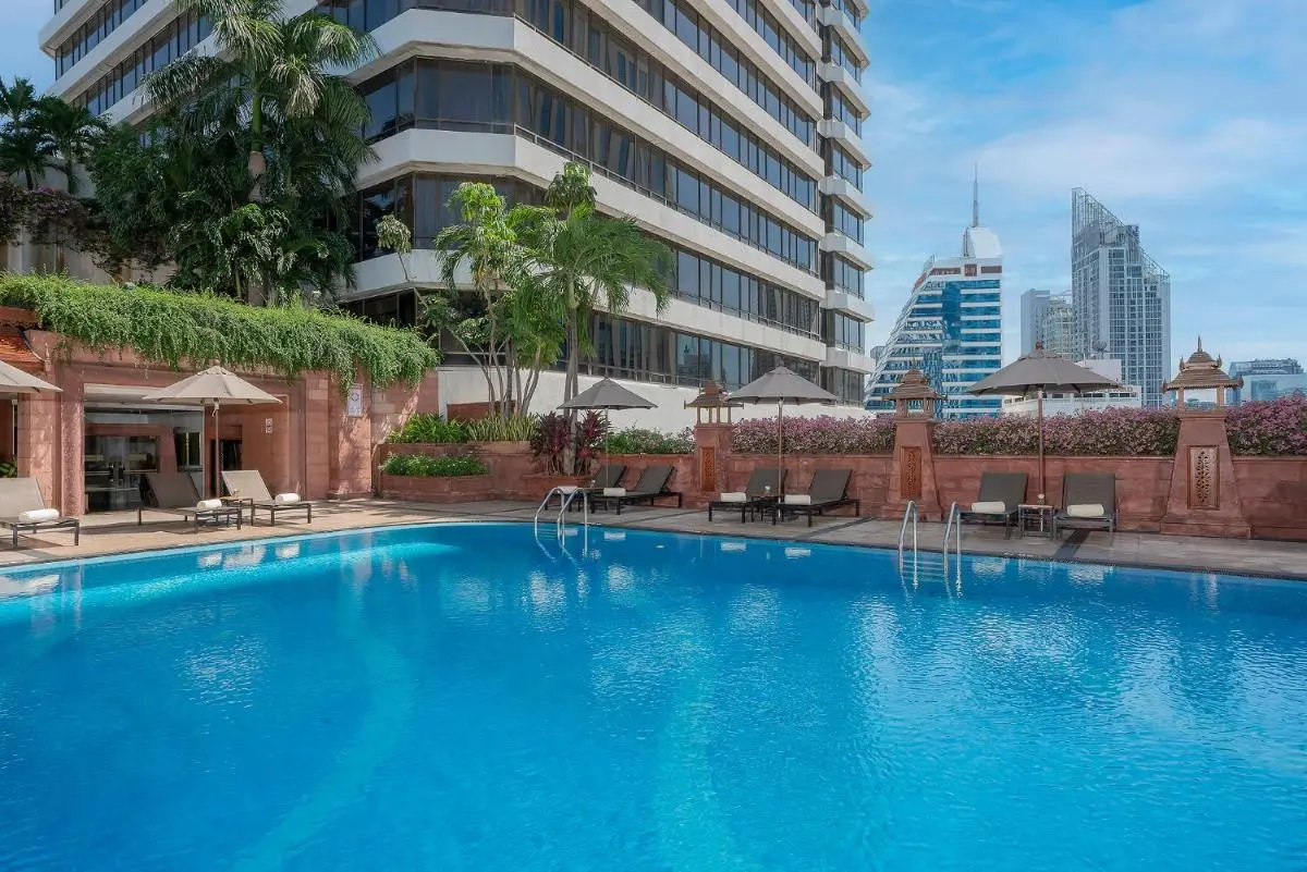 The Landmark Bangkok Outdoor Swimming Pool Area with Lounge Chairs and City Views in Khlong Toei Bangkok