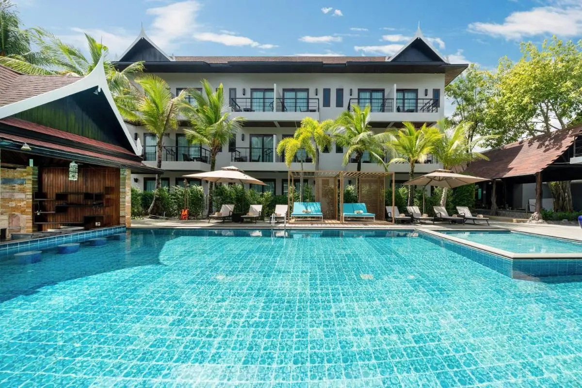 Outdoor Swimming Pool Area with Lounge Chairs and Covered Seating in Thalang