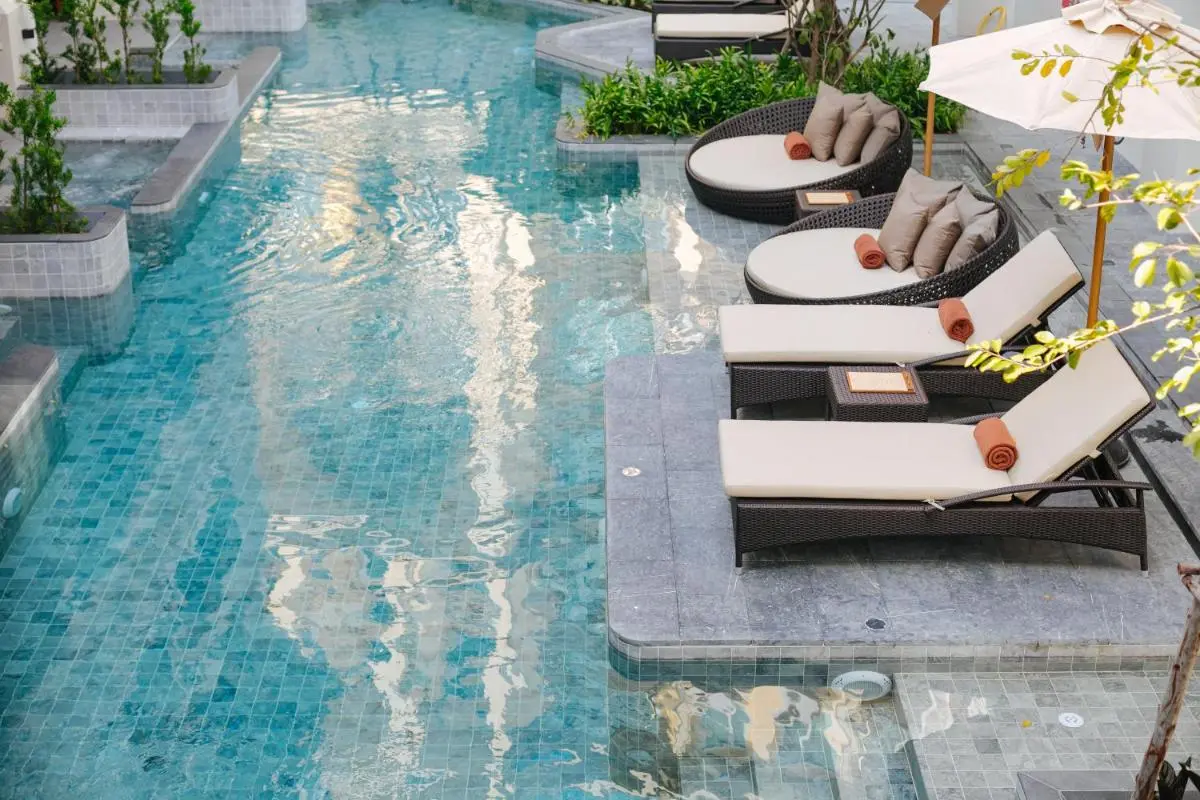 Outdoor Swimming Pool Area with Lounge Chairs and Daybeds in Chiang Mai