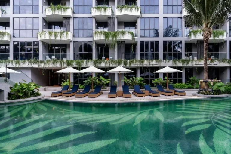 Outdoor Swimming Pool Area with Lounge Chairs and Greenery at Bang Tao Beach