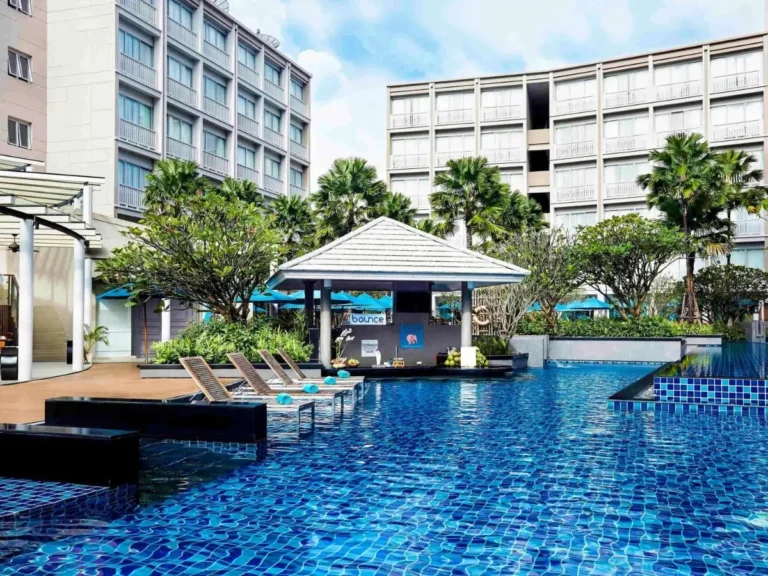 Outdoor Swimming Pool Area with Lounge Chairs and Pavilion Near Patong Beach
