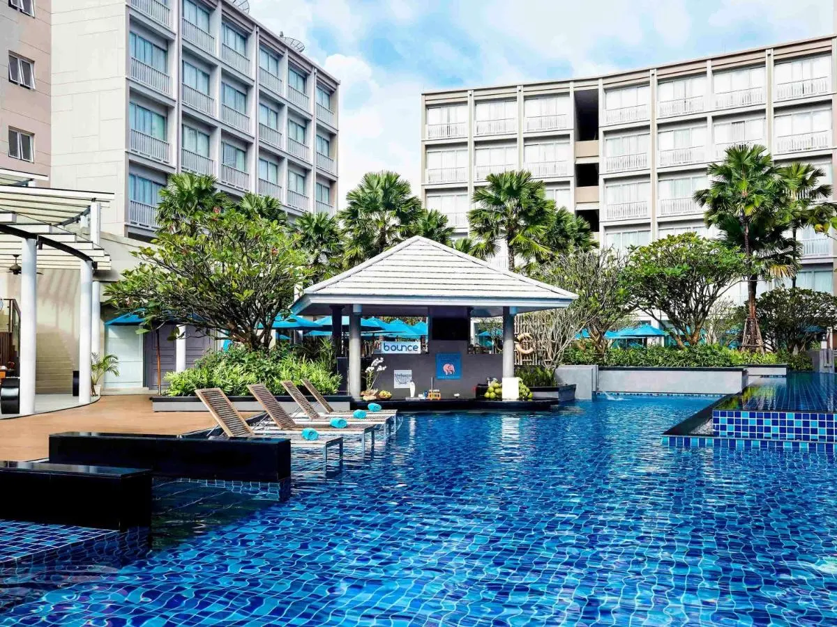 Outdoor Swimming Pool Area with Lounge Chairs and Pavilion Near Patong Beach