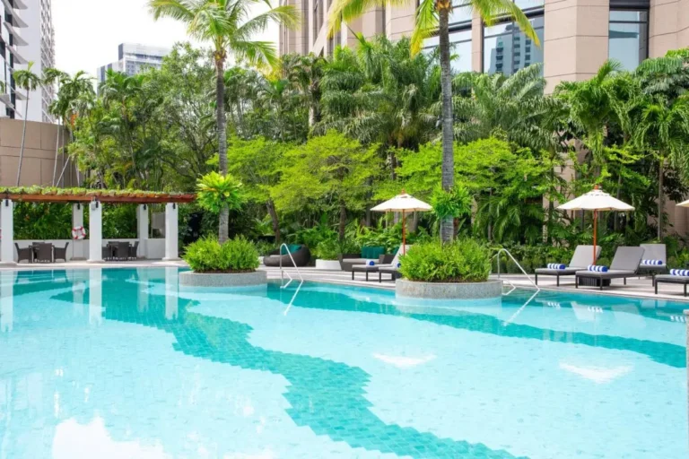 Outdoor Swimming Pool Area with Lounge Chairs and Pergola Seating in Khlong Toei