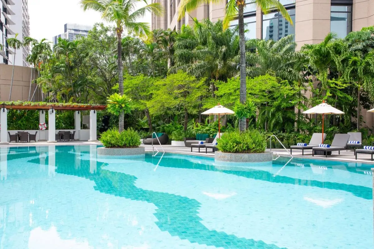 Outdoor Swimming Pool Area with Lounge Chairs and Pergola Seating in Khlong Toei