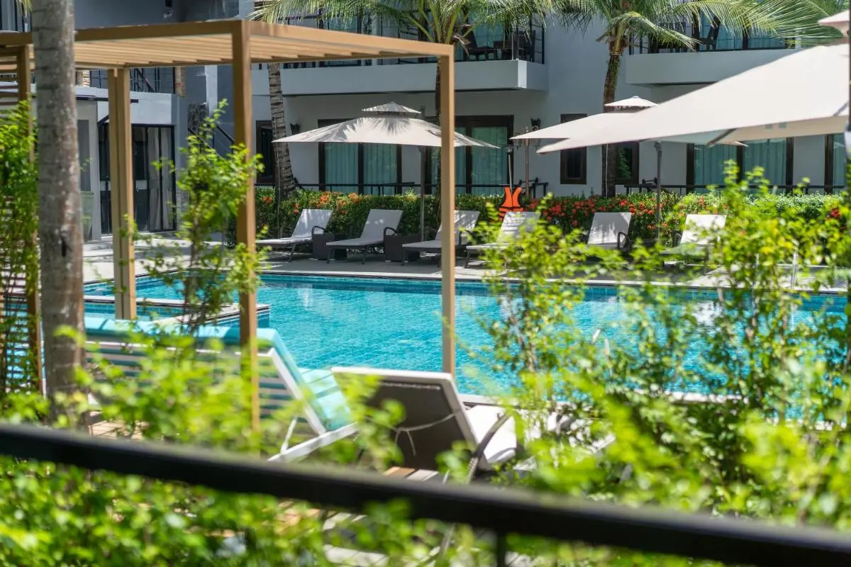 Outdoor Swimming Pool Area with Lounge Chairs and Pergolas in Thalang