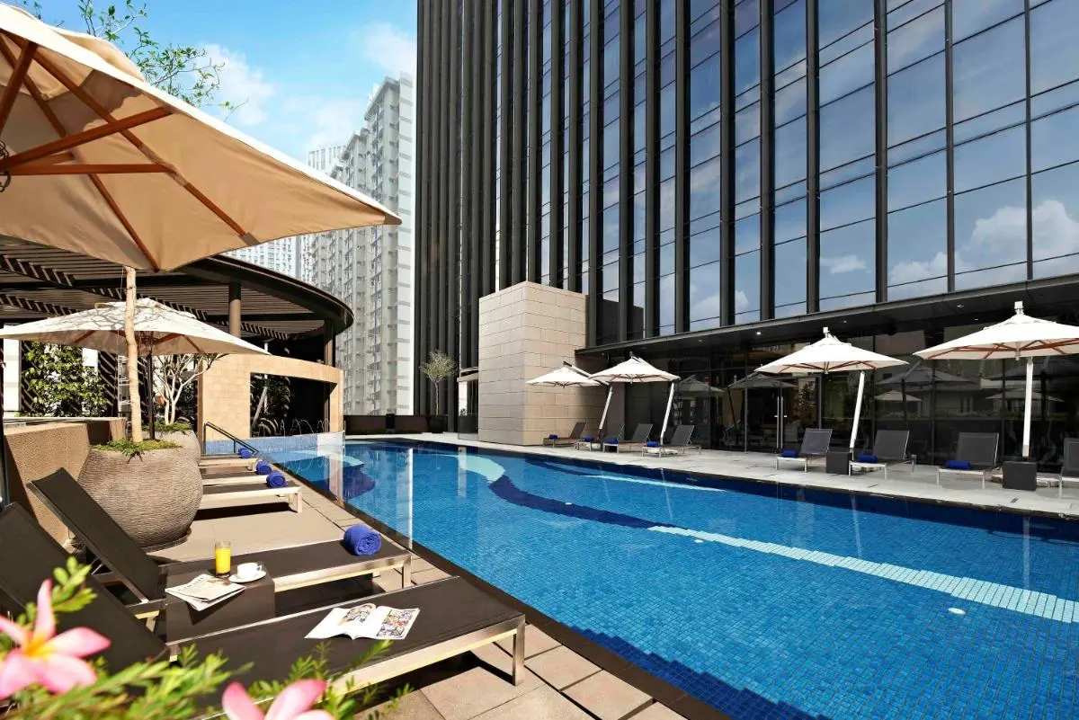 Outdoor Swimming Pool Area with Lounge Chairs and Shade in Chinatown Singapore