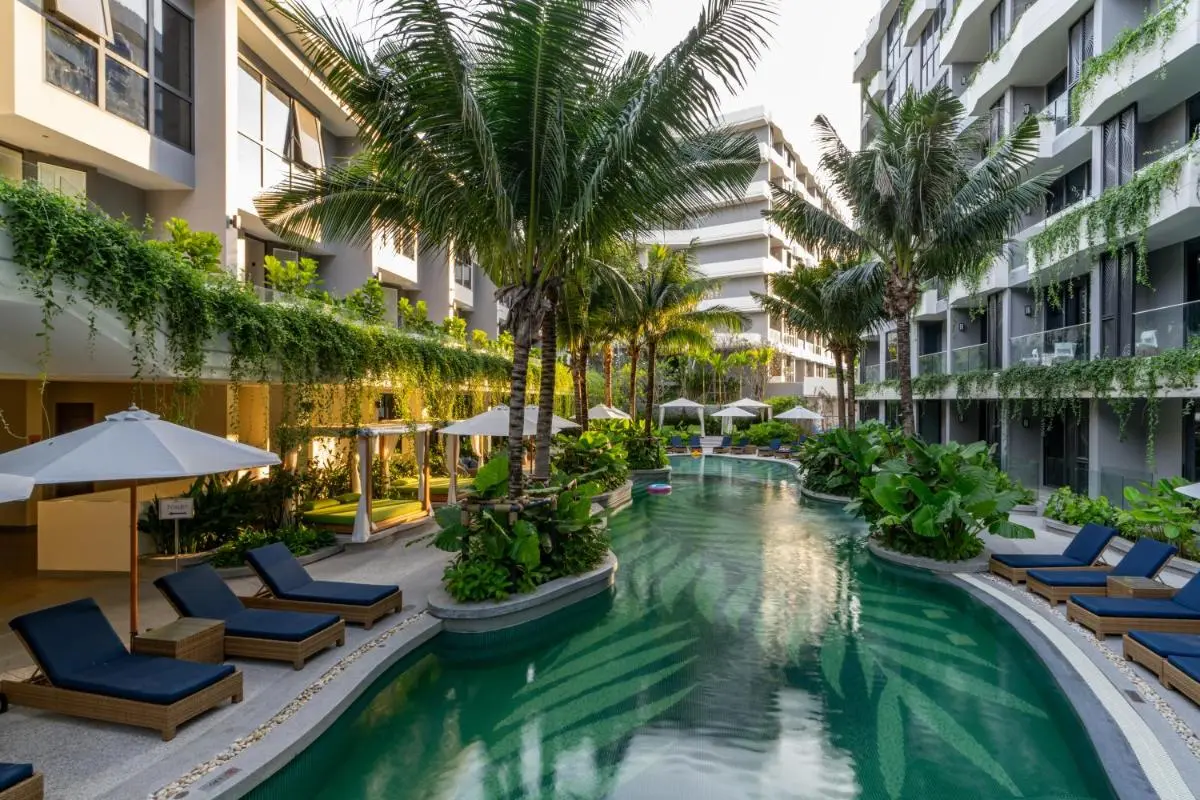 Outdoor Swimming Pool Area with Lounge Chairs and Tropical Landscaping at Bang Tao Beach