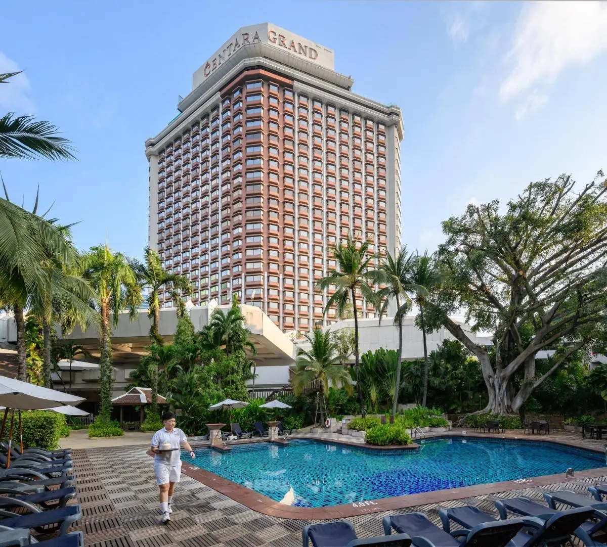 Centara Grand at Central Plaza Ladprao Bangkok Outdoor Swimming Pool Area with Lounge Chairs and Tropical Landscaping in Chatuchak Bangkok