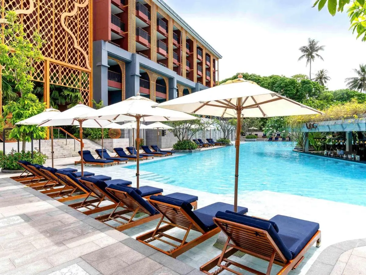 Avista Grande Phuket Karon - MGallery Outdoor Swimming Pool Area with Lounge Chairs and Umbrellas at Karon Beach