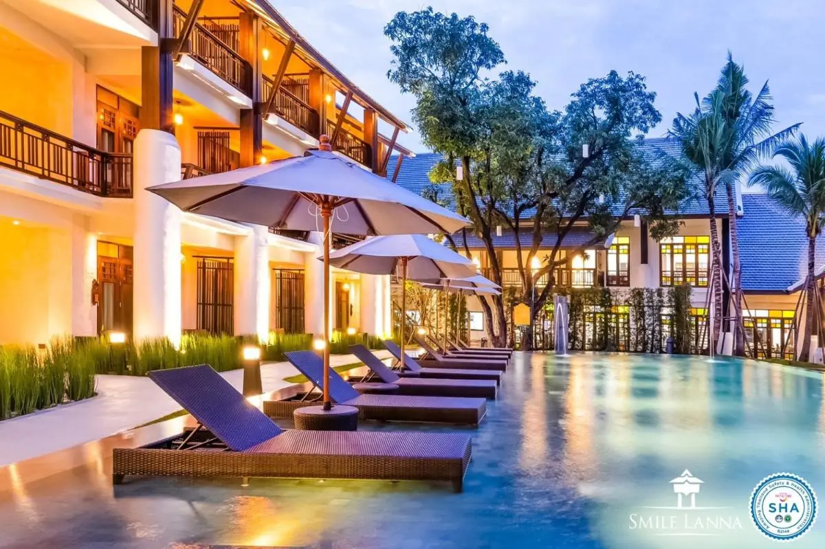 Outdoor Swimming Pool Area with Lounge Chairs and Umbrellas in Hai Ya Chiang Mai
