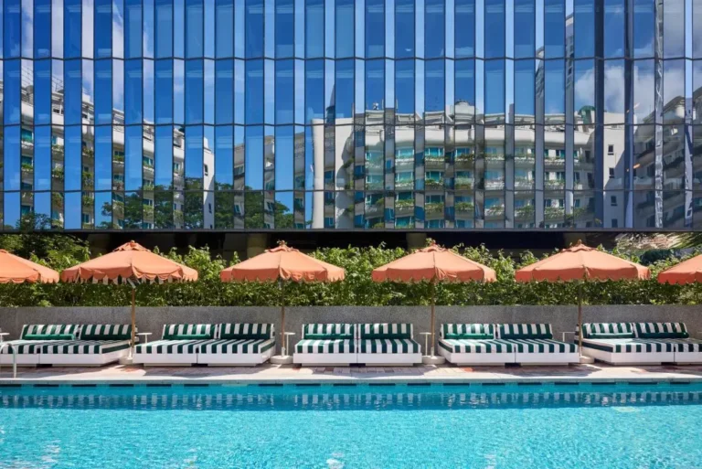 Outdoor Swimming Pool Area with Lounge Chairs and Umbrellas in Orchard Singapore