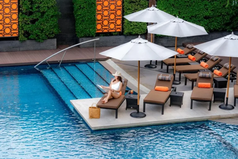 Outdoor Swimming Pool Area with Lounge Chairs and Umbrellas in Wattana Bangkok