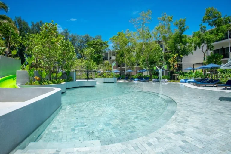 Outdoor Swimming Pool Area with Lounge Chairs and Water Slide at Mai Khao Beach