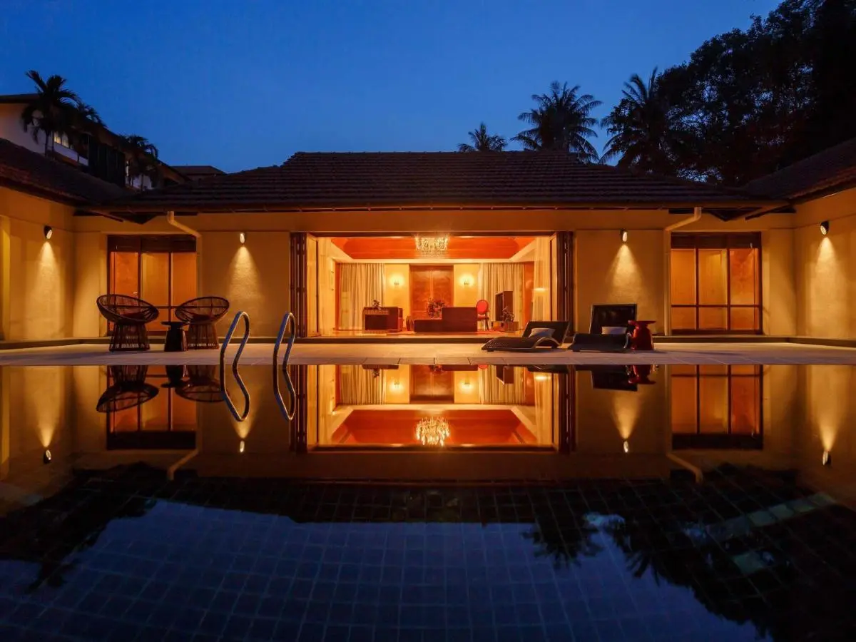 Sofitel Singapore Sentosa Outdoor Swimming Pool Area with Lounge Seating and Indoor Living Space in Singapore
