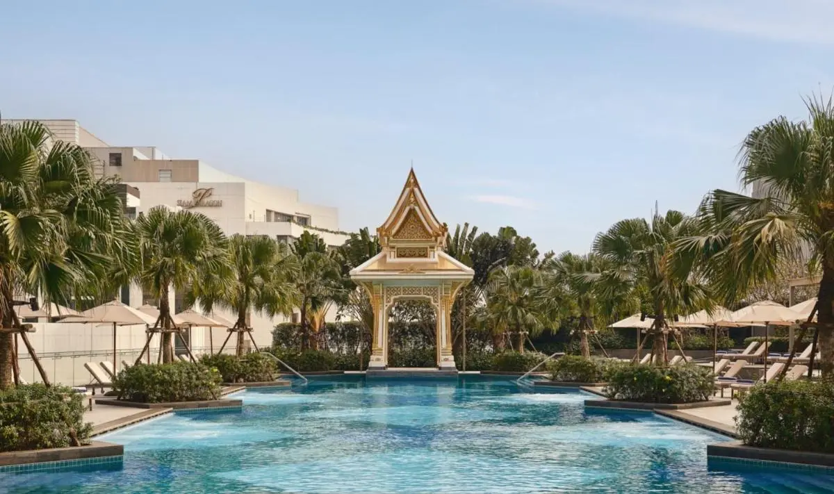 Chatrium Grand Bangkok Outdoor Swimming Pool Area with Pavilion and Palm Trees in Ratchathewi Bangkok