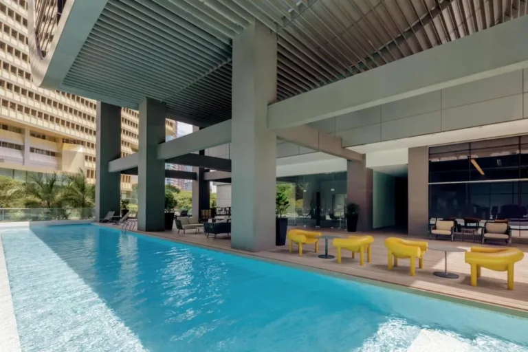 Outdoor Swimming Pool Area with Seating and Lounge in Singapore Urban Setting