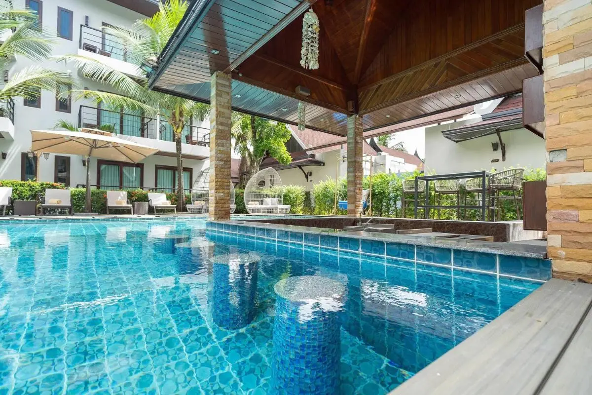 Outdoor Swimming Pool Area with Swim-Up Bar and Tropical Seating in Thalang