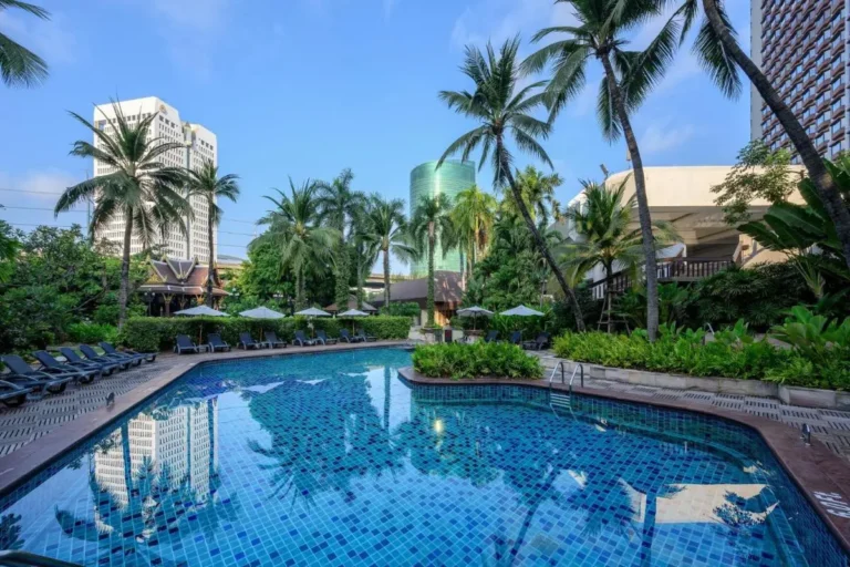 Outdoor Swimming Pool Area with Tropical Landscaping and Lounge Seating in Chatuchak Bangkok